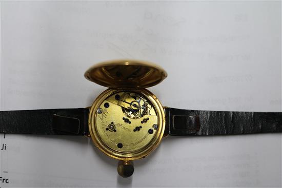 An 18ct gold half hunter wrist watch by Ashley & Sims, Clerkenwell, on leather strap.